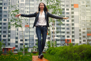 Raising Teenagers - Young teenage girl balancing and walking along a beam