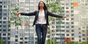 Female teenager walking on a balance beam in a park